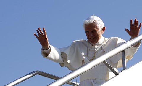 pope benedict xvi waves as he boards the plane for his flight to spain from rome's ciampino airport