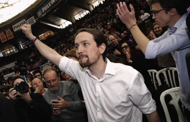 podemos-we-can-party-secretary-general-pablo-iglesias-c-lifts-his-fist-next-to-party-member-inigo-errejon-during-a-party-meeting-in-valencia-january-25-2015-reuters-heino-kalis-spain-tags-politics