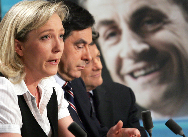 (From left to right) Marine Le Pen, daughter of France's far-right Front national party's (FN) president Jean-Marie Le Pen, French right-wing candidate Nicolas Sarkozy's political advisor Francois Fillon and French Minister for Employment, Social Cohesion and Housing Jean-Louis Borloo take part in a debate as a picture of Nicolas Sarkozy appears on a giant screen, on the set of TF1 TV channel late 22 April 2007, in Boulogne-Billancourt, after the closing of the vote for the first round of the French presidential elections. According to unofficial estimates from four polling firms Rightwinger Nicolas Sarkozy and Socialist Segolene Royal will contest a runoff after winning most votes in the first round of France's presidential election next 6 May. AFP PHOTO PIERRE VERDY