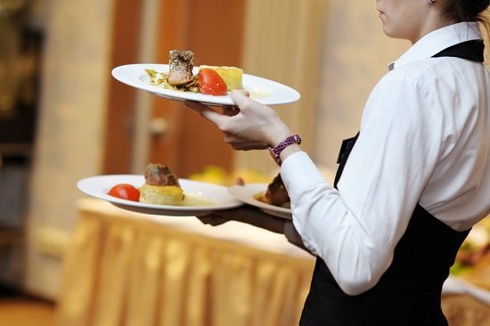 39464135 - waitress is carrying three plates with meat dish