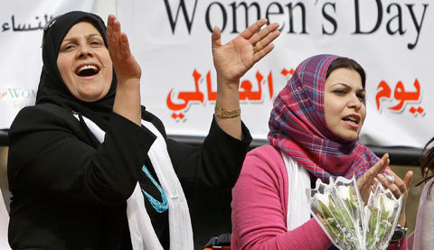 iraqi women applaud during a celebration of international women's day in baghdad, iraq, tuesday, march 8, 2011. (ap photo/hadi mizban)