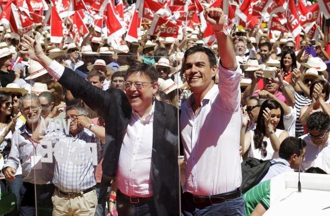 socialist-party-psoe-secretary-general-sanchez-greets-next-to-regional-presidential-candidate-puig-as-he-arrives-at-an-electoral-meeting-at-the-bull-ring-in-valencia