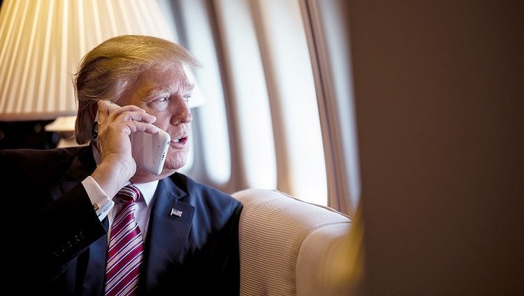 President Donald Trump talks on the phone aboard Air Force One during a flight to Philadelphia, Pennsylvania, to address a joint gathering of House and Senate Republicans, Thursday, January 26, 2017. This was the President...s first Trip aboard Air Force One. (Official White House Photo by Shealah Craighead)