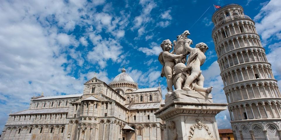 Angels Statue, Pisa Cathedral (Duomo di Pisa) (forefront), The Leaning Tower of Pisa (background), Piazza dei Miracoli ("Square of Miracles"). Pisa, Tuscany, Central Italy.