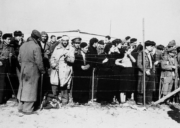 16 Feb 1939, Le Perthus, France --- Le Perthus, France: Concentration Camp A Haven---The thought of concentration camps, Nazi style, is one to send a chill of dread running up and down our spines. To these Spanish refugees, fleeing before Franco's victorious insurgent armies. The concentration camp at Le Perthus, just across the Spanish border is a haven of security, offering food, shelter and safety. Care of these refugees present a major problem to the French as the exodus across the border runs into the hundreds of thousands. --- Image by © Bettmann/CORBIS
