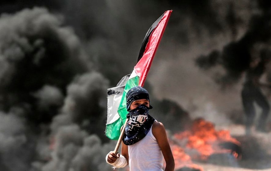 Dozens of Palestinians were killed by Israeli fire on May 14 as tens of thousands protested and clashes erupted along the Gaza border against the US transfer of its embassy to Jerusalem, after months of global outcry, Palestinian anger and exuberant praise from Israelis over President Donald Trump's decision tossing aside decades of precedent. / AFP PHOTO / MAHMUD HAMS