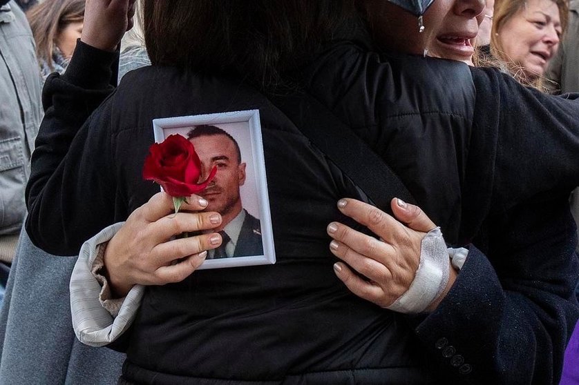 Un familiar con la fotografía de Miguel Ángel González durante su funeral.