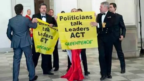greenpeace activists are led away in copenhagen