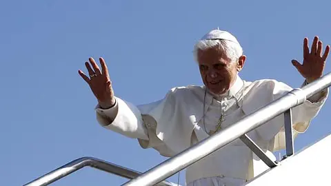 pope benedict xvi waves as he boards the plane for his flight to spain from rome's ciampino airport