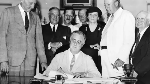 Roosevelt signs Social Security Bill