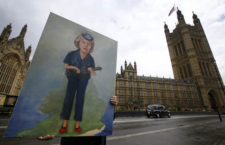 Artist Kaya Mar displays his painting of Britain's Home Secretary Theresa May near parliament in London, Tuesday, July 12, 2016. Theresa May will become Britain's new Prime Minister on Wednesday. (AP Photo/Kirsty Wigglesworth)